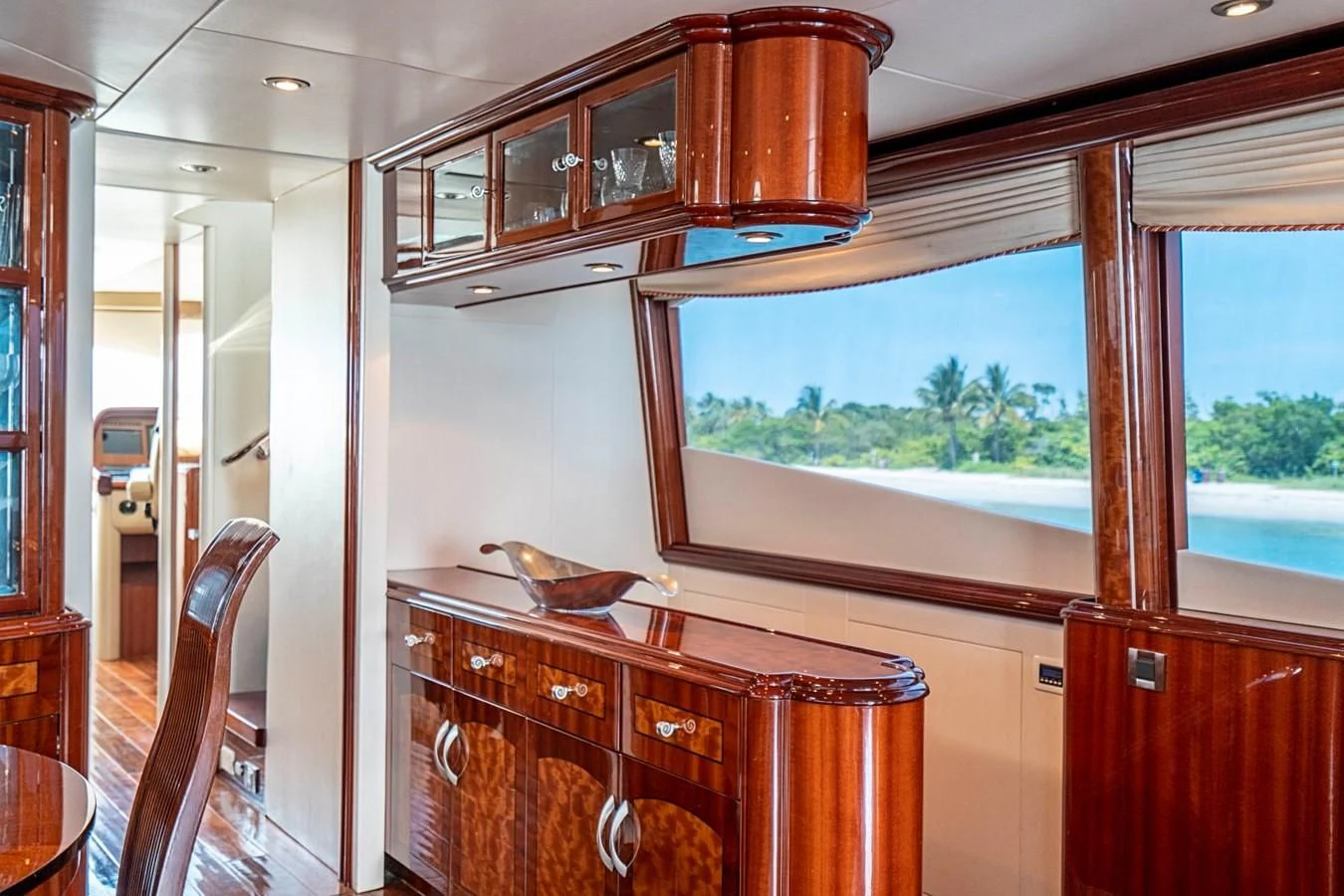 a kitchen with a wood cabinet and a wooden island aboard RENDEZVOUS Yacht for Sale