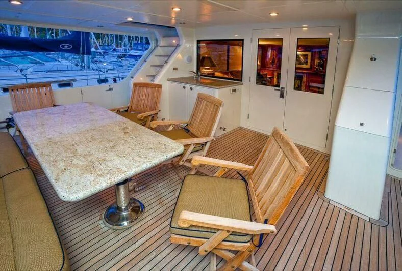 a large living room with a large bed and a table aboard AL DI LA Yacht for Sale