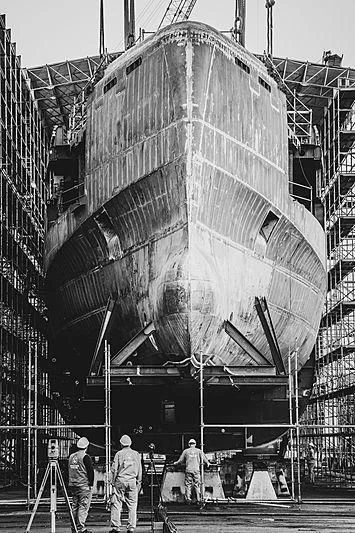 men working on a large machine aboard BLACK SHARK Yacht for Sale