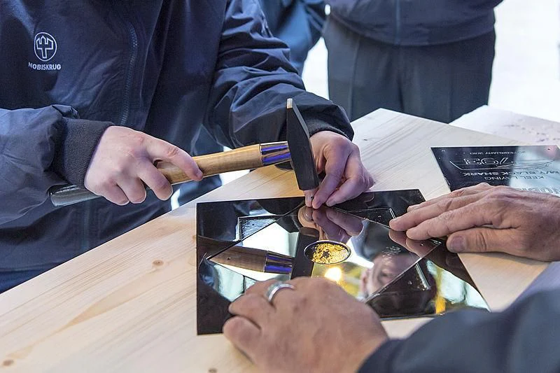 a few people holding a pen aboard BLACK SHARK Yacht for Sale