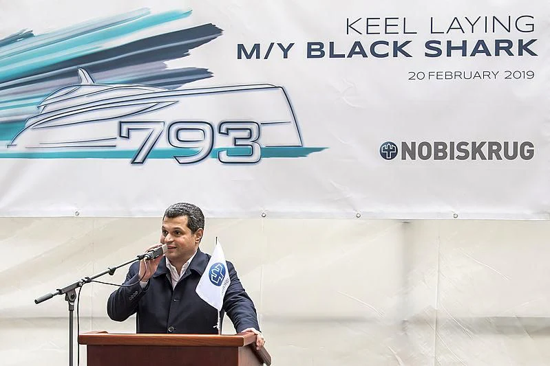a person speaking into a microphone aboard BLACK SHARK Yacht for Sale