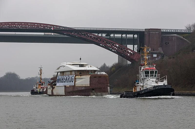 a large boat carrying a barge aboard BLACK SHARK Yacht for Sale