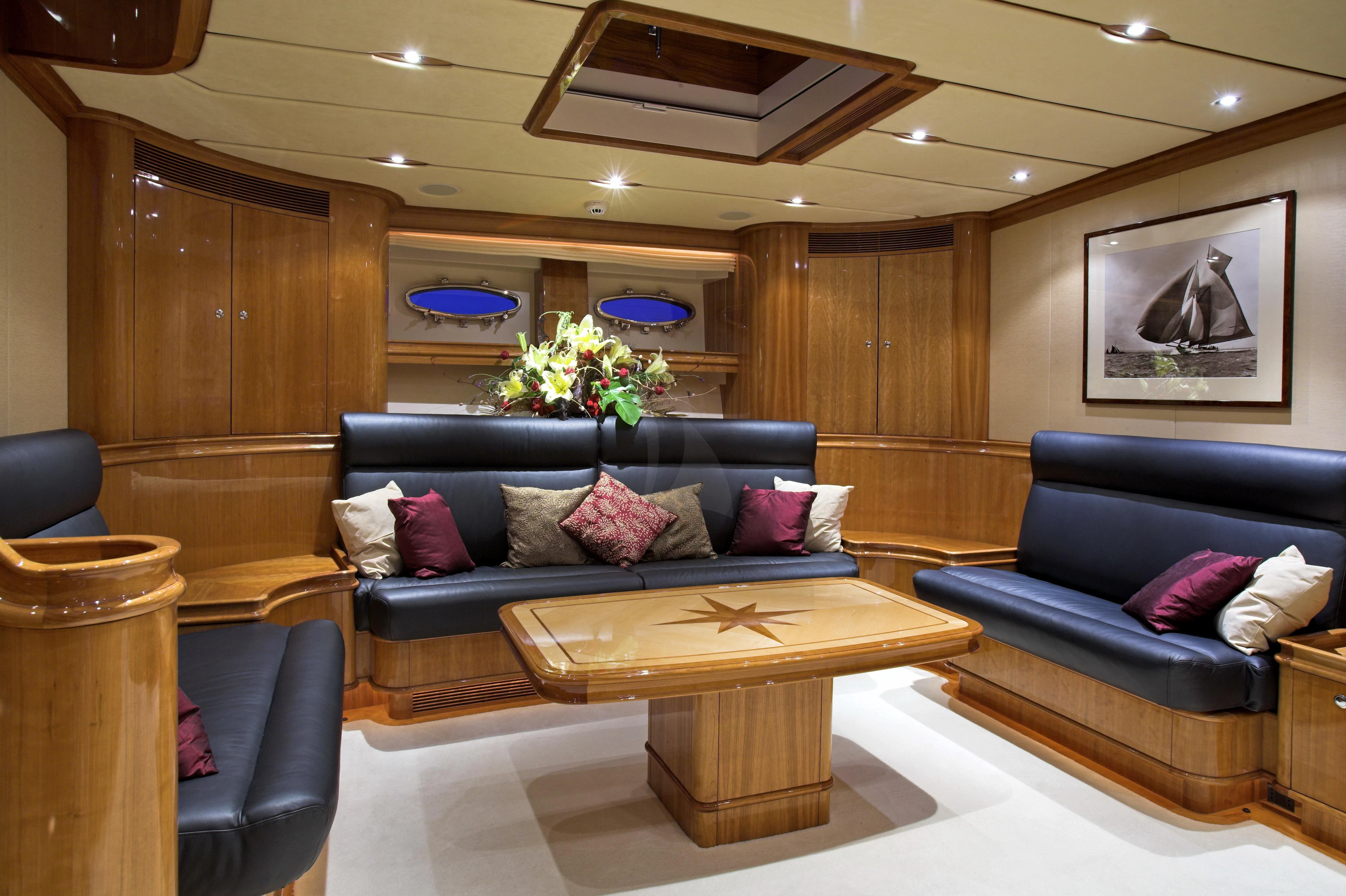 a living room with a couch and a coffee table aboard SEABISCUIT Yacht for Sale
