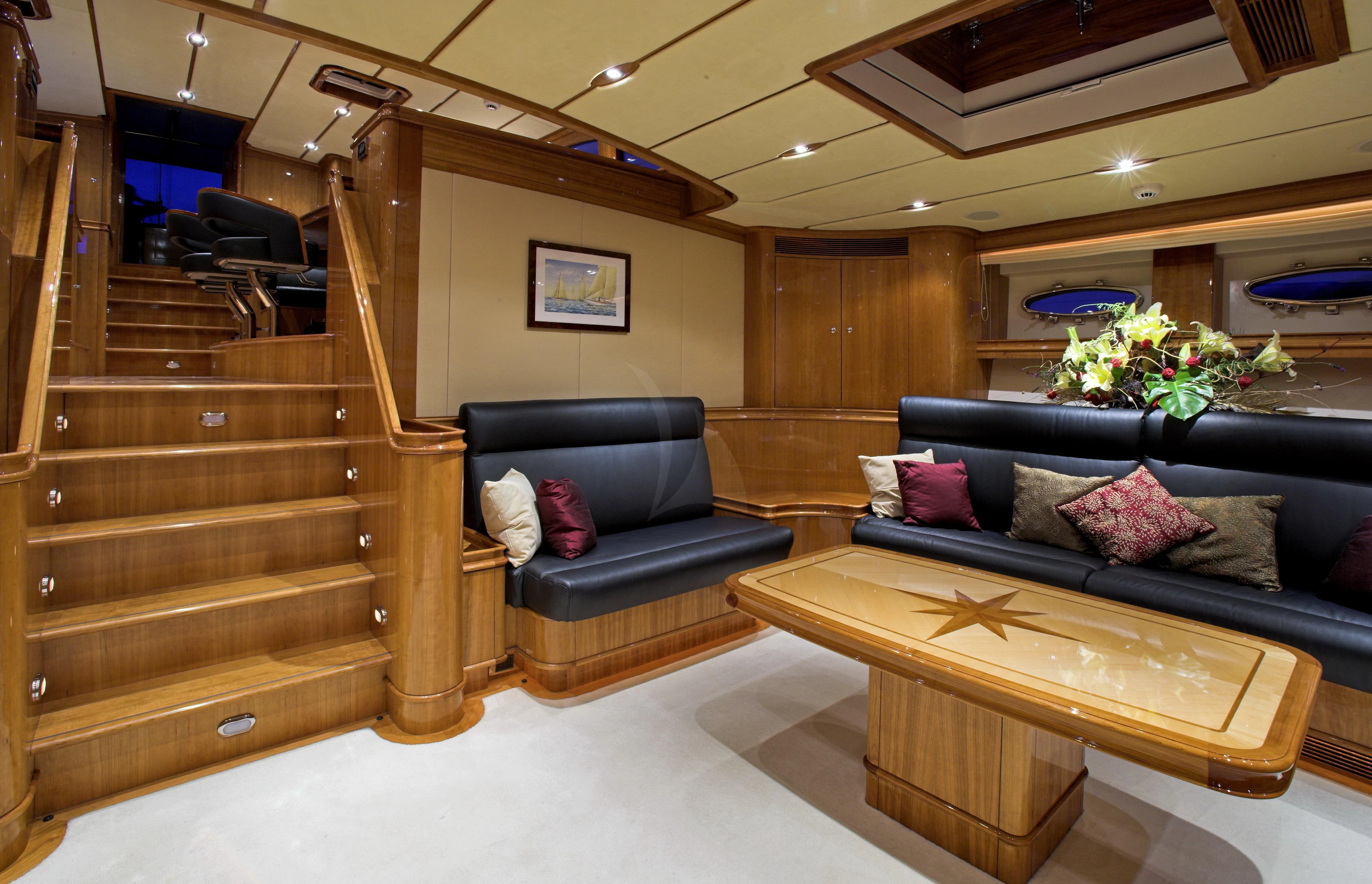 a living room with a wood staircase aboard SEABISCUIT Yacht for Sale