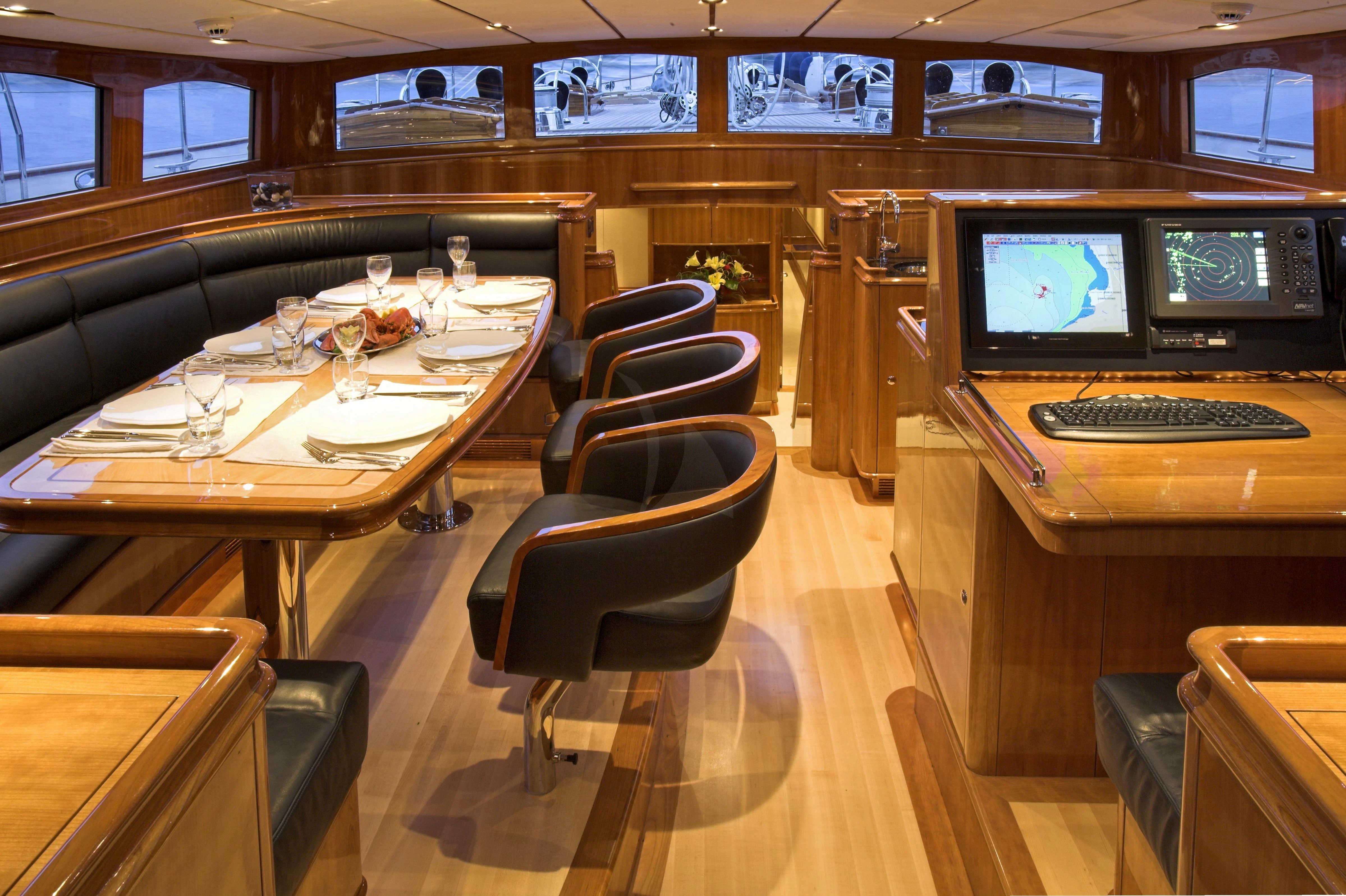 a room with a table and chairs aboard SEABISCUIT Yacht for Sale