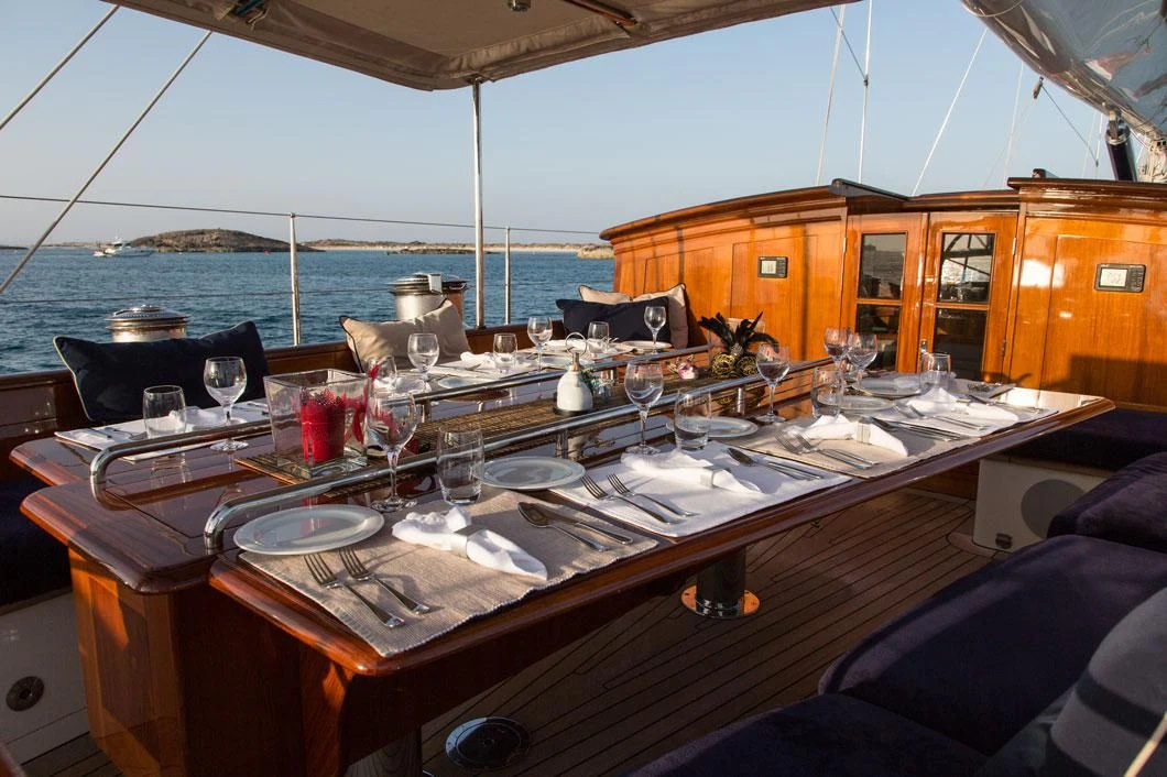 a table with plates and glasses on it aboard SEABISCUIT Yacht for Sale