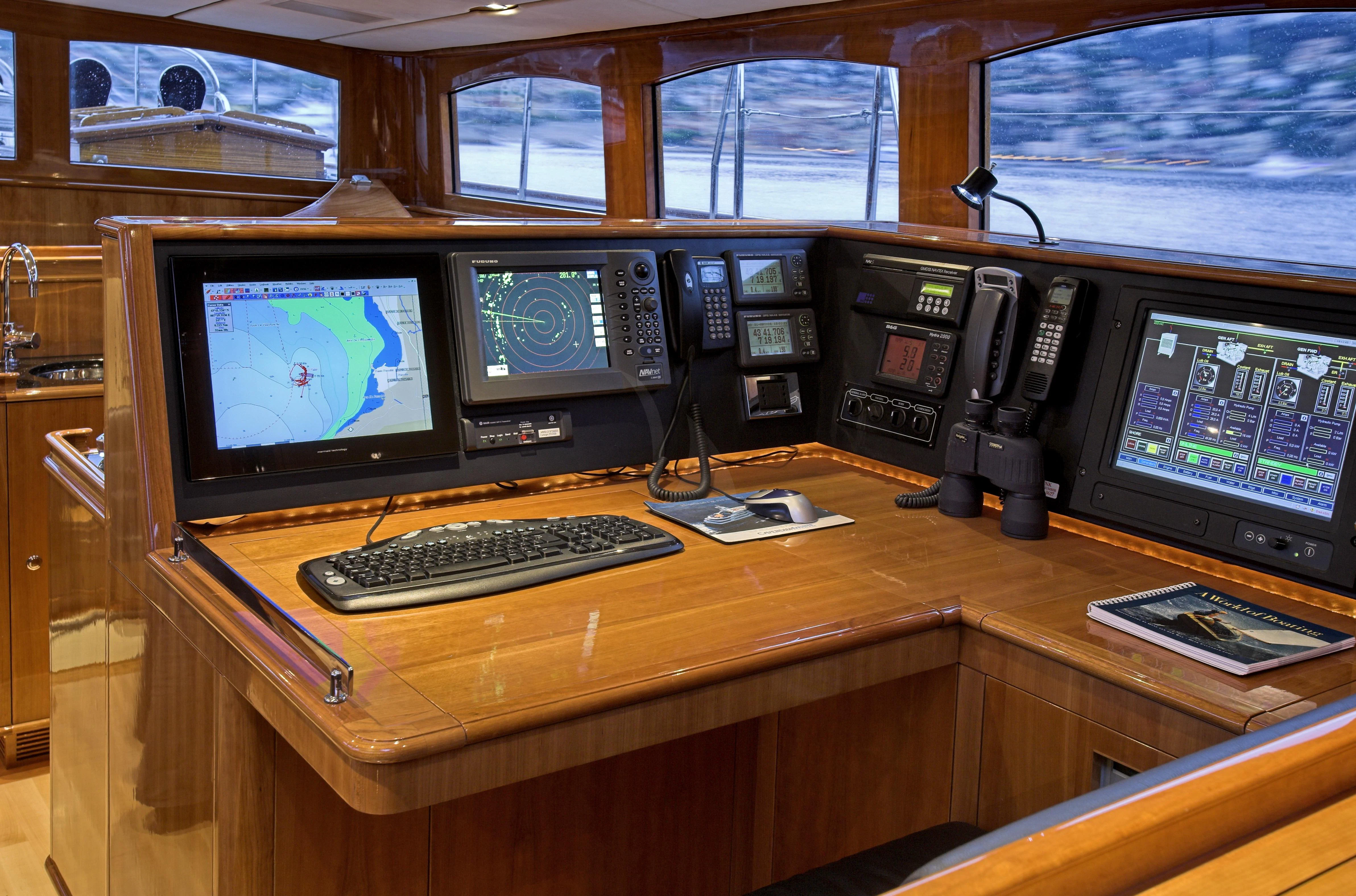 a desk with computers and telephones aboard SEABISCUIT Yacht for Sale