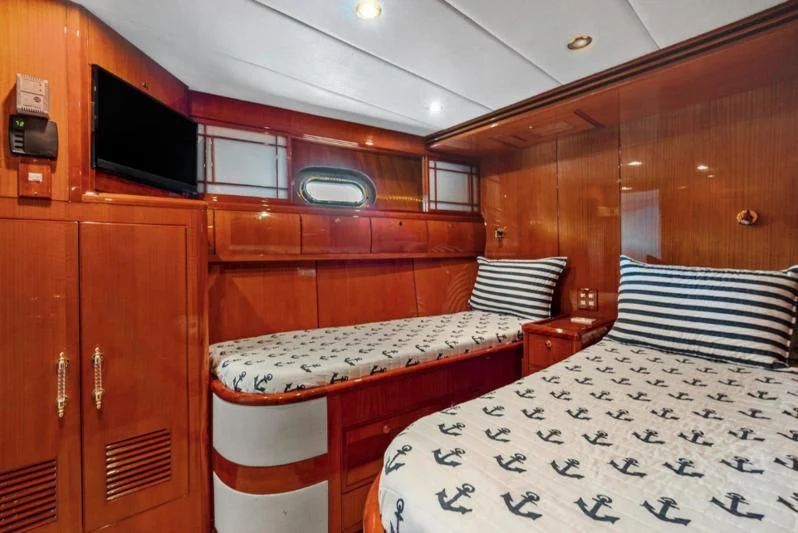 a cabin with a bed and a table aboard MENTORSHIP IV Yacht for Sale