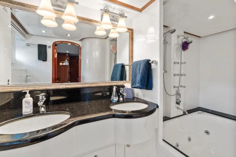 a bathroom with a large mirror aboard MENTORSHIP IV Yacht for Sale