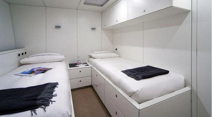 a room with a bed and a desk aboard RUNNING ON FAITH Yacht for Sale