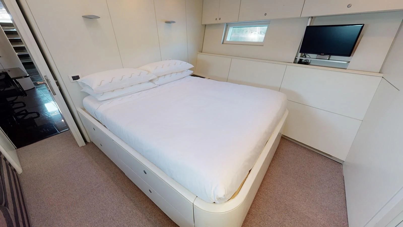 a room with a bed and a television aboard RUNNING ON FAITH Yacht for Sale