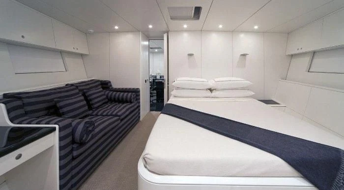 a room with a bed and a desk aboard RUNNING ON FAITH Yacht for Sale