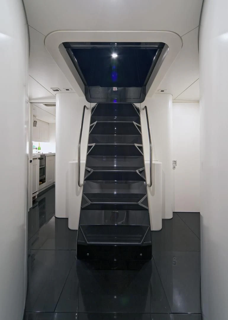 a black and white staircase aboard RUNNING ON FAITH Yacht for Sale