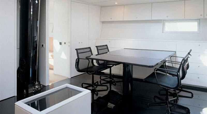 a room with a table and chairs aboard RUNNING ON FAITH Yacht for Sale