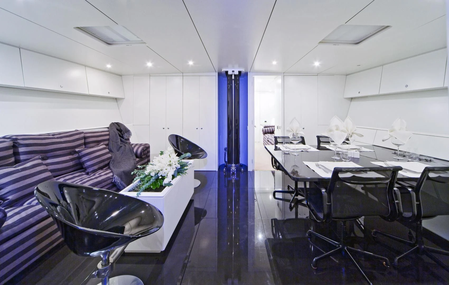 a room with a table and chairs aboard RUNNING ON FAITH Yacht for Sale