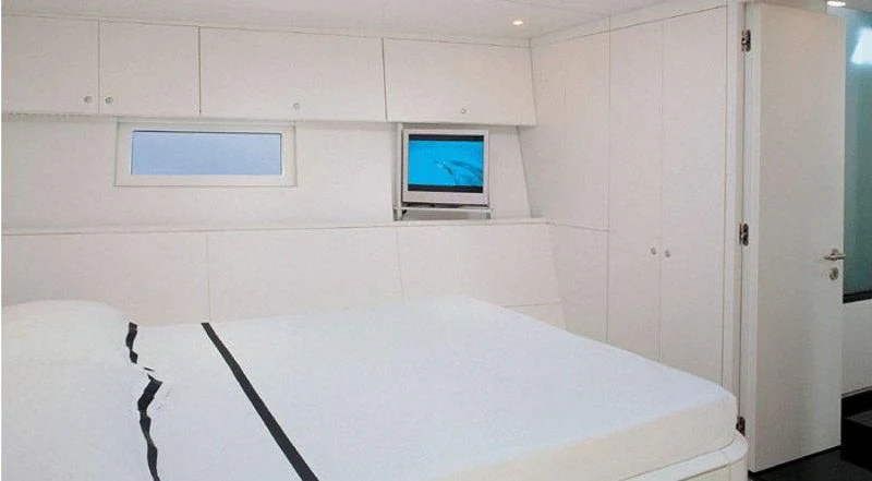 a room with a table and a tv on the wall aboard RUNNING ON FAITH Yacht for Sale