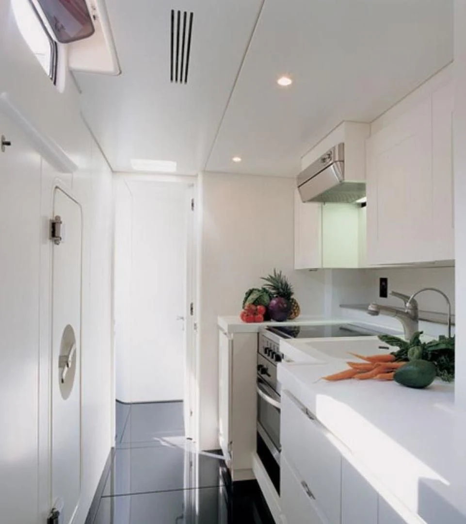 a kitchen with white cabinets aboard RUNNING ON FAITH Yacht for Sale