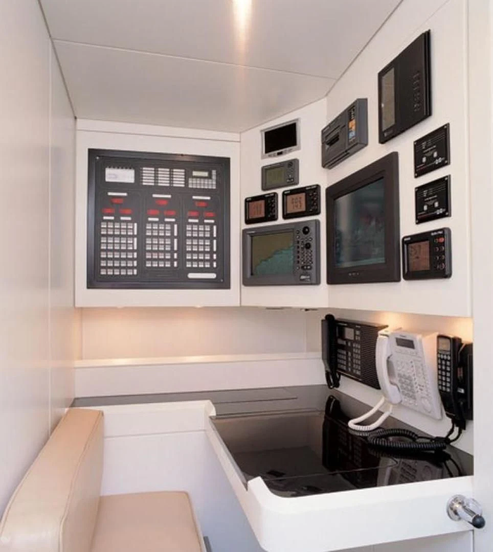 a room with computers and telephones aboard RUNNING ON FAITH Yacht for Sale