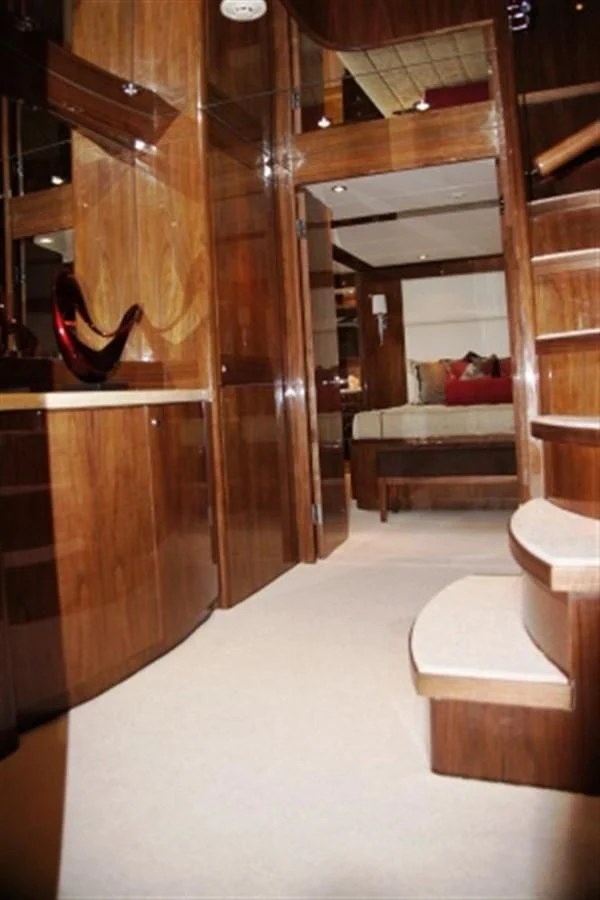 a room with a bed and a couch aboard EBITDA Yacht for Sale