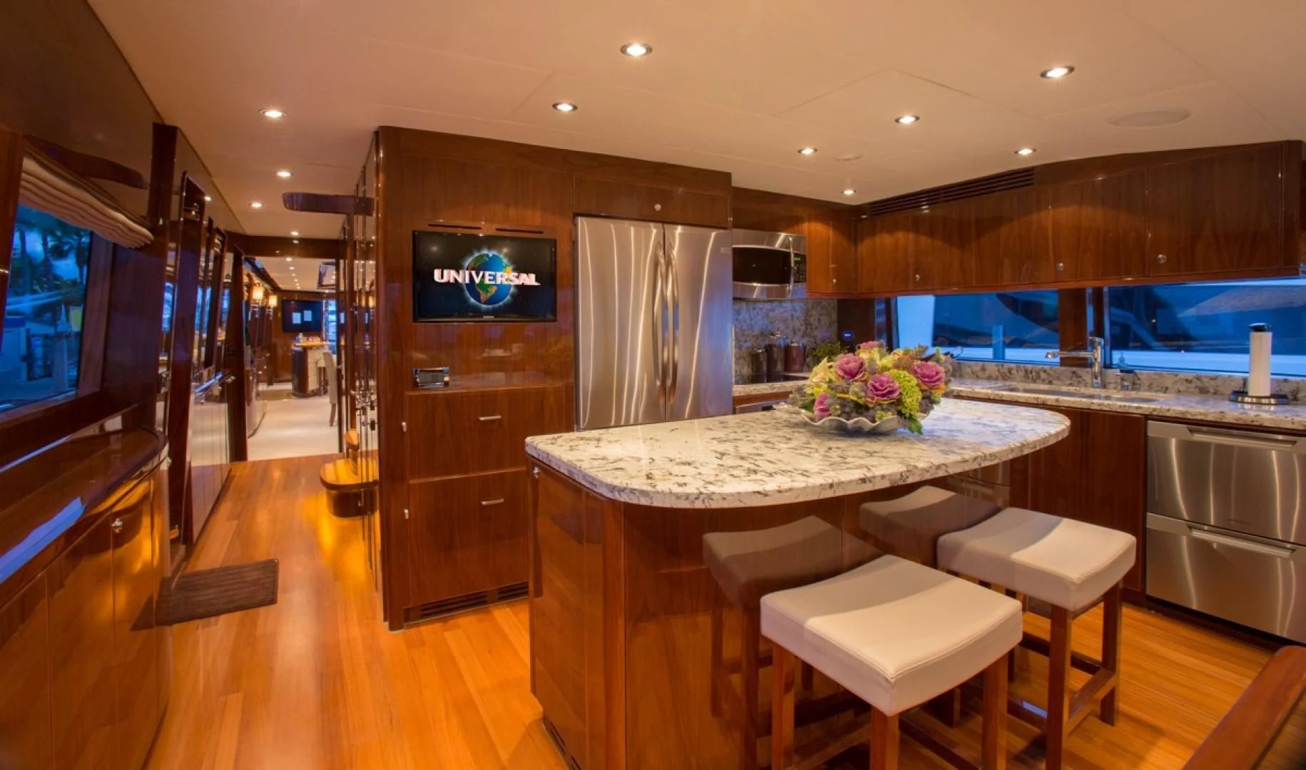 a kitchen with a bar and stools aboard EBITDA Yacht for Sale