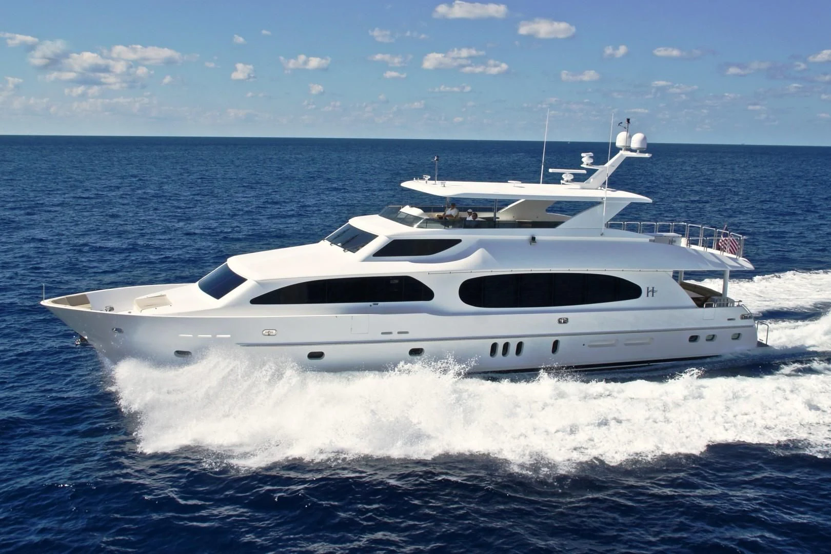 a white yacht on the water aboard EBITDA Yacht for Sale