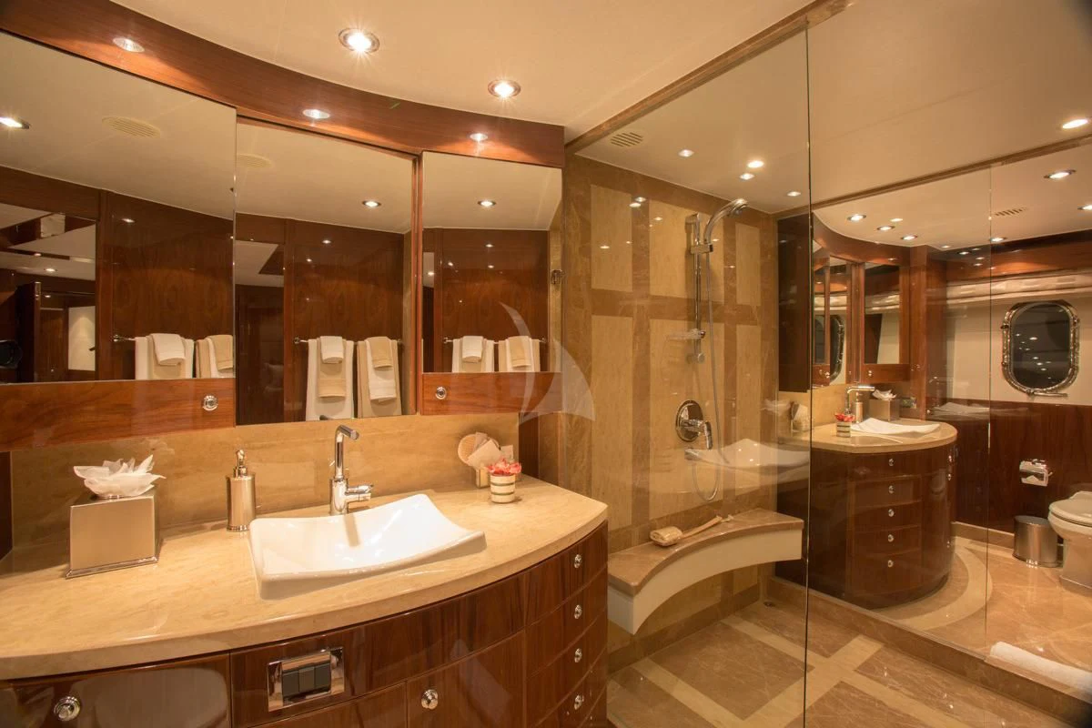 a bathroom with a large mirror aboard EBITDA Yacht for Sale