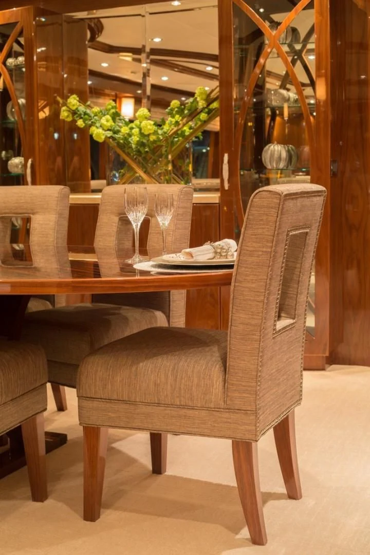 a table with chairs and a plant on it aboard EBITDA Yacht for Sale