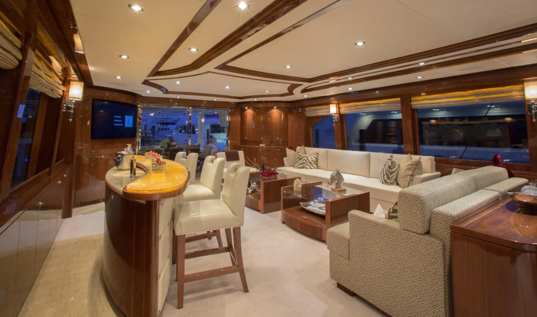 a room with a couch and a table and a tv aboard EBITDA Yacht for Sale