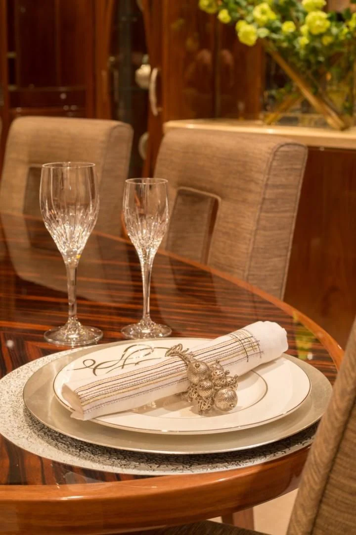 a plate with a cake and glasses on it aboard EBITDA Yacht for Sale
