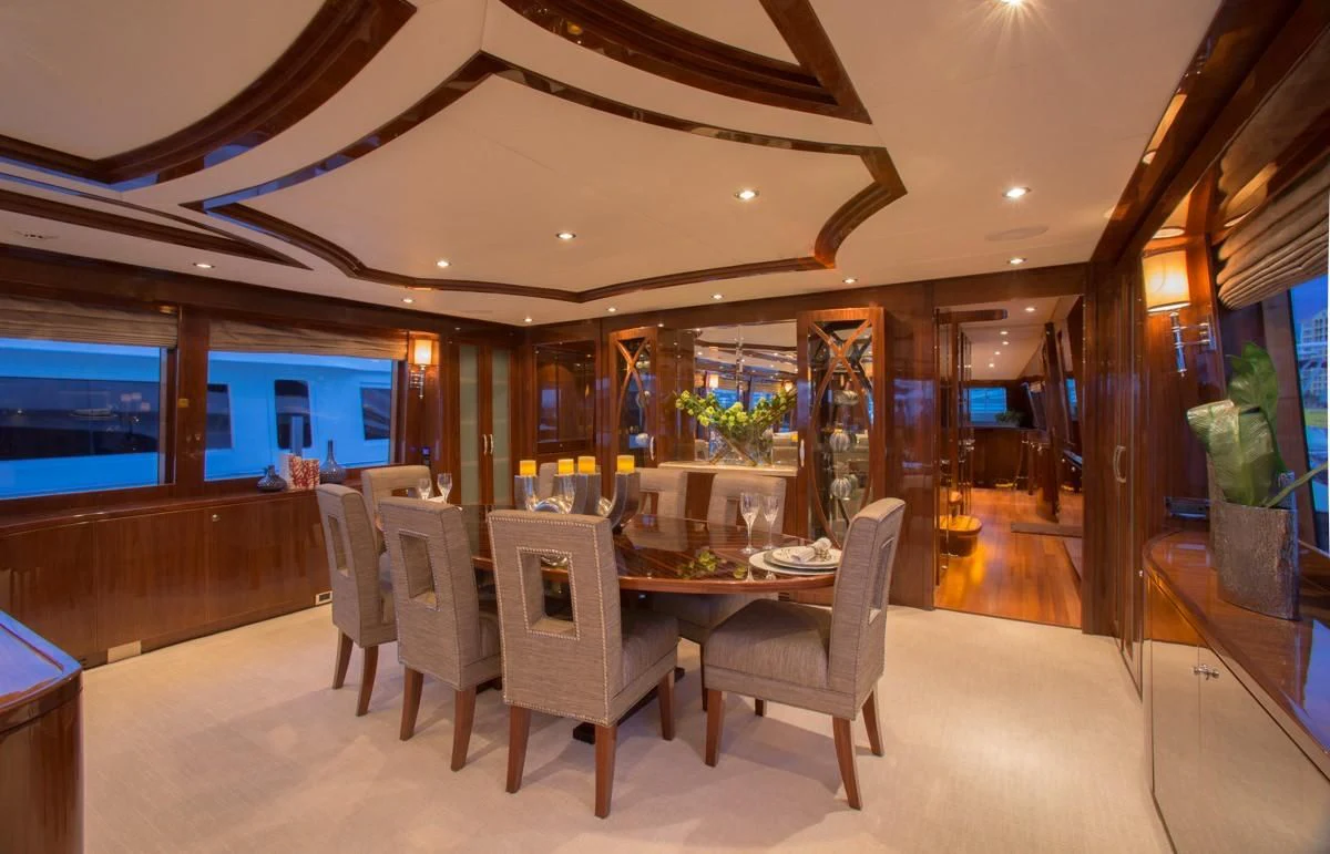 a room with a table and chairs aboard EBITDA Yacht for Sale