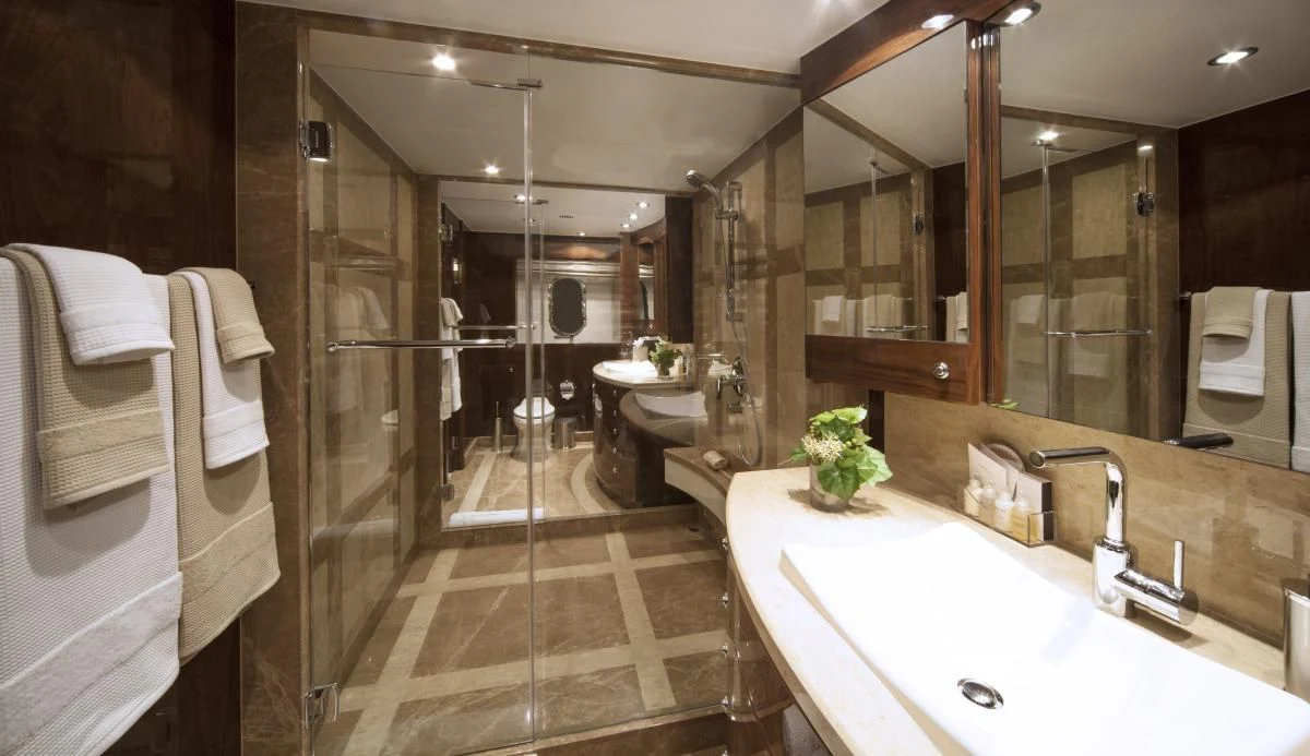 a bathroom with a large mirror aboard EBITDA Yacht for Sale