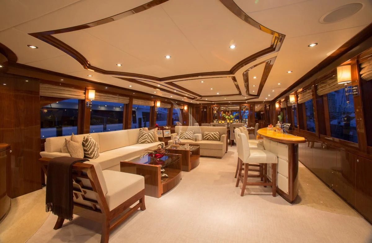 a room with a couch and a table and chairs aboard EBITDA Yacht for Sale