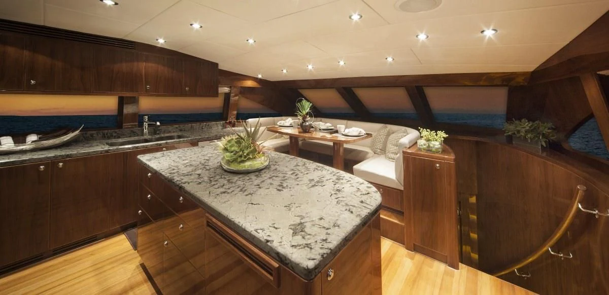 a kitchen with a large island aboard EBITDA Yacht for Sale