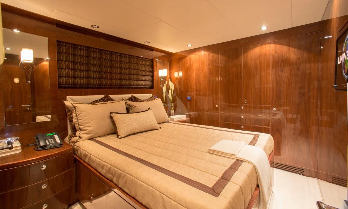 a hotel room with a bed aboard EBITDA Yacht for Sale