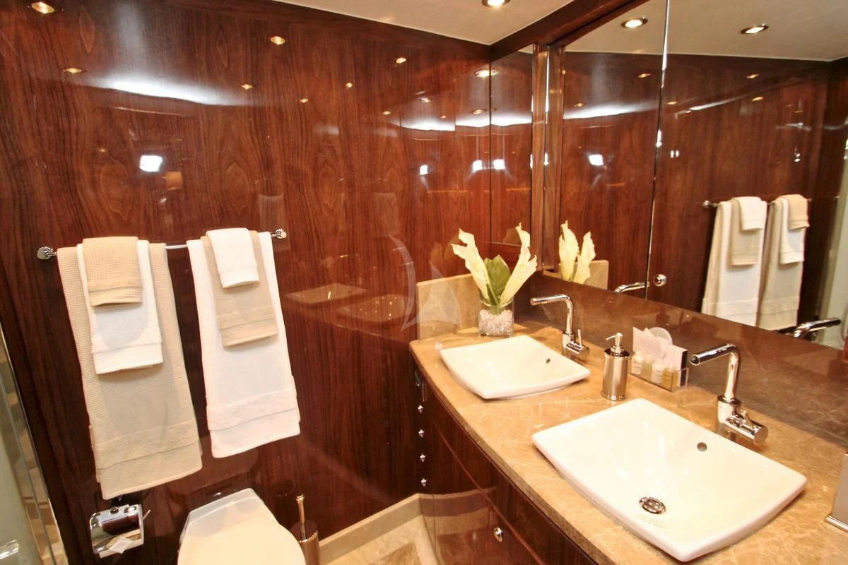 a bathroom with a large mirror aboard EBITDA Yacht for Sale
