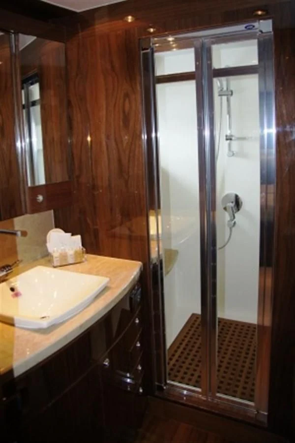 a bathroom with a sink and a shower aboard EBITDA Yacht for Sale