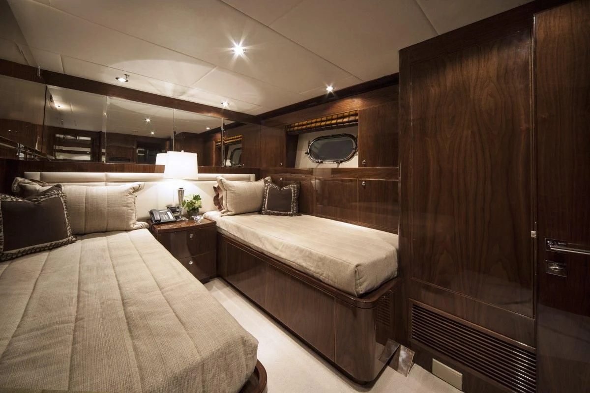 a room with a bed and a mirror aboard EBITDA Yacht for Sale