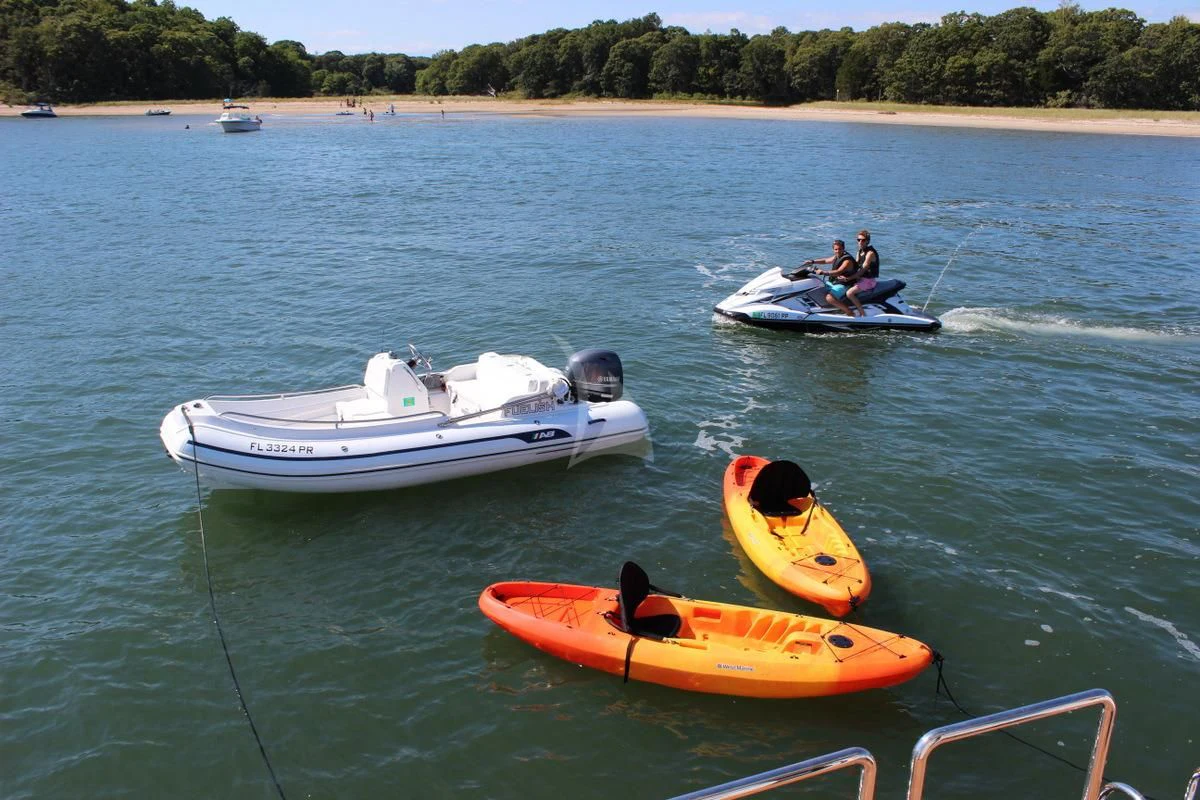 a group of people in boats in the water aboard EBITDA Yacht for Sale
