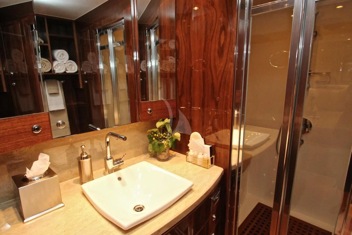 a bathroom with a sink and a mirror aboard EBITDA Yacht for Sale