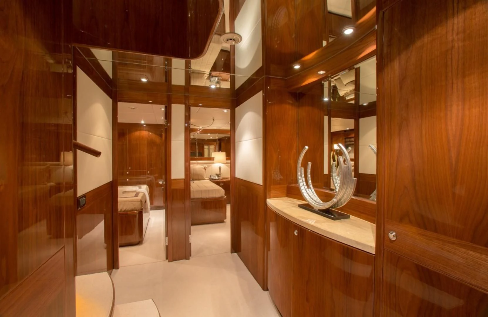 a room with a large mirror and a table aboard EBITDA Yacht for Sale