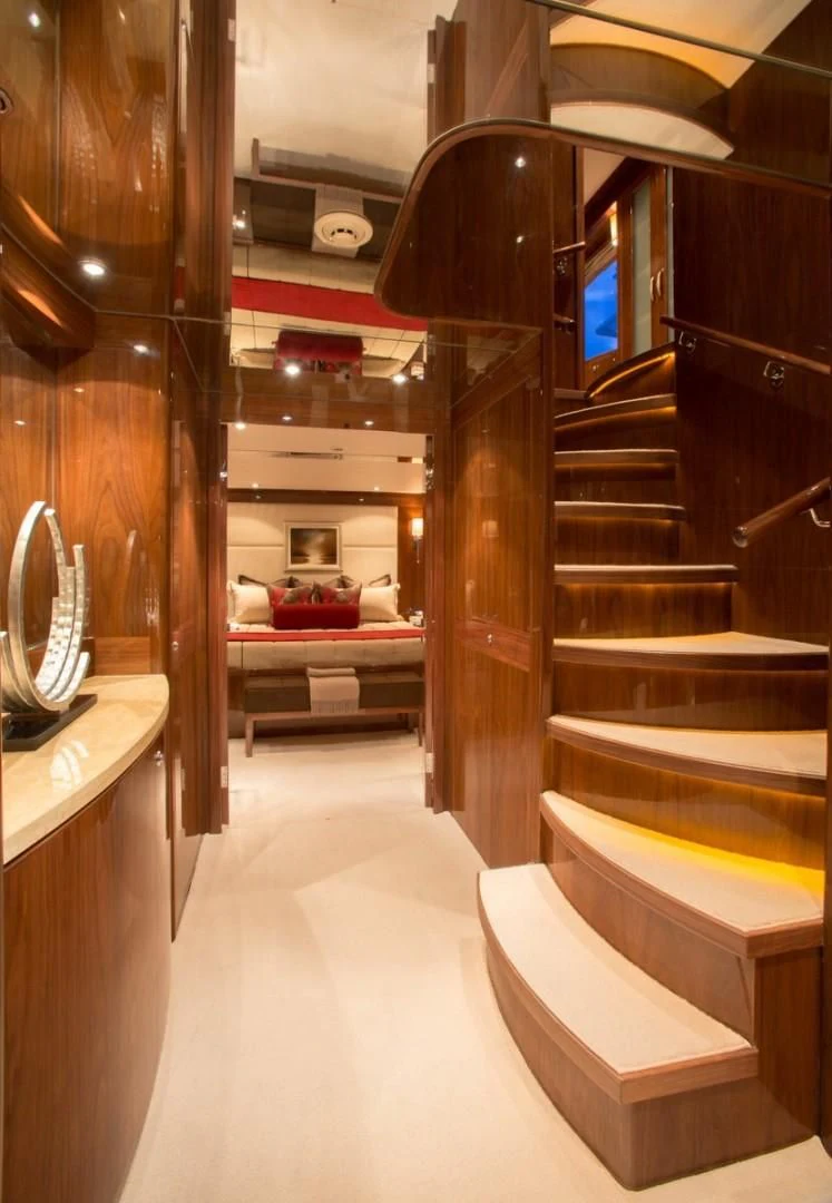 a room with a bed and a mirror aboard EBITDA Yacht for Sale