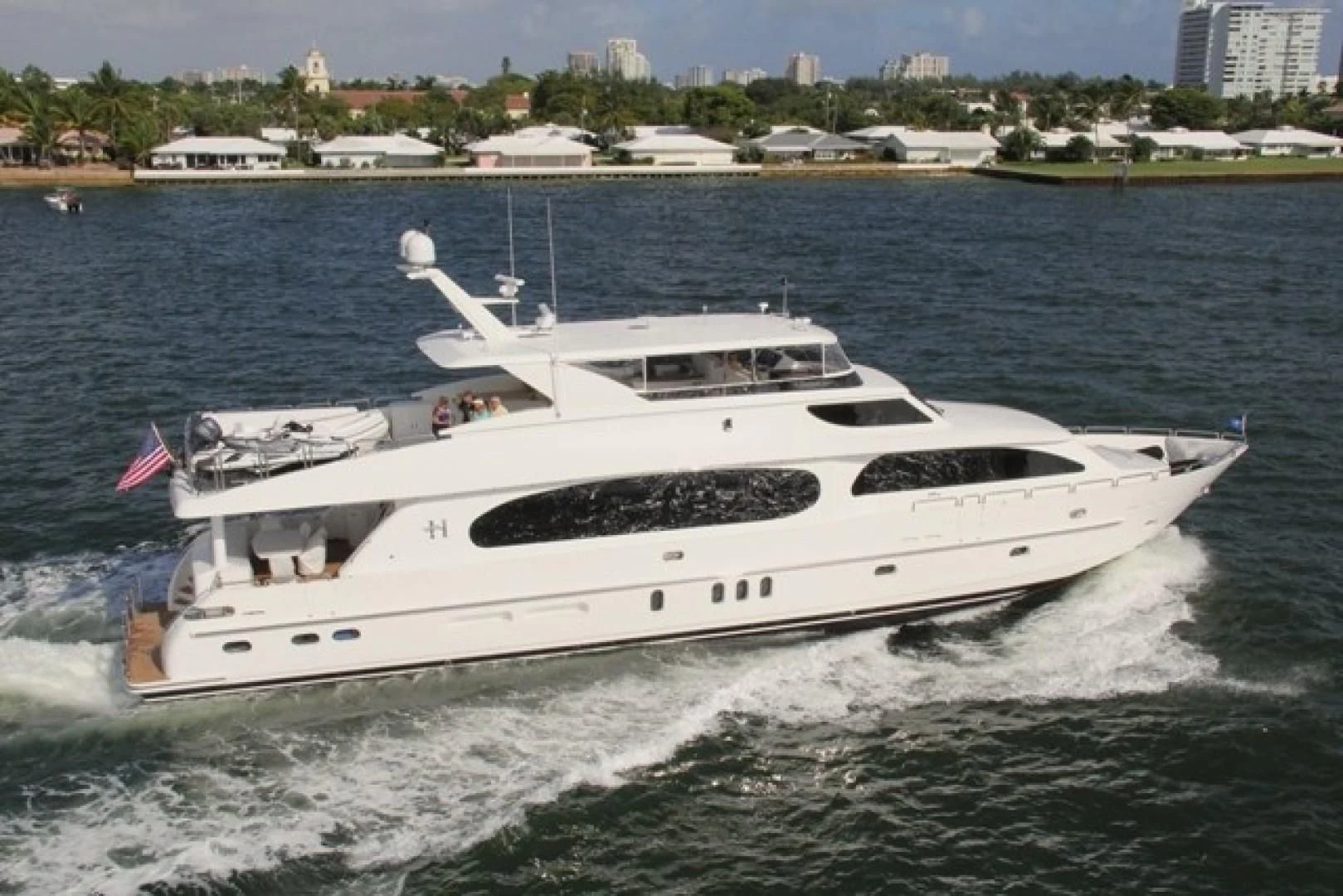 a white yacht on the water aboard EBITDA Yacht for Sale