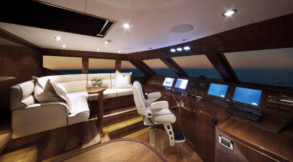 a room with a couch and a desk with a computer aboard EBITDA Yacht for Sale
