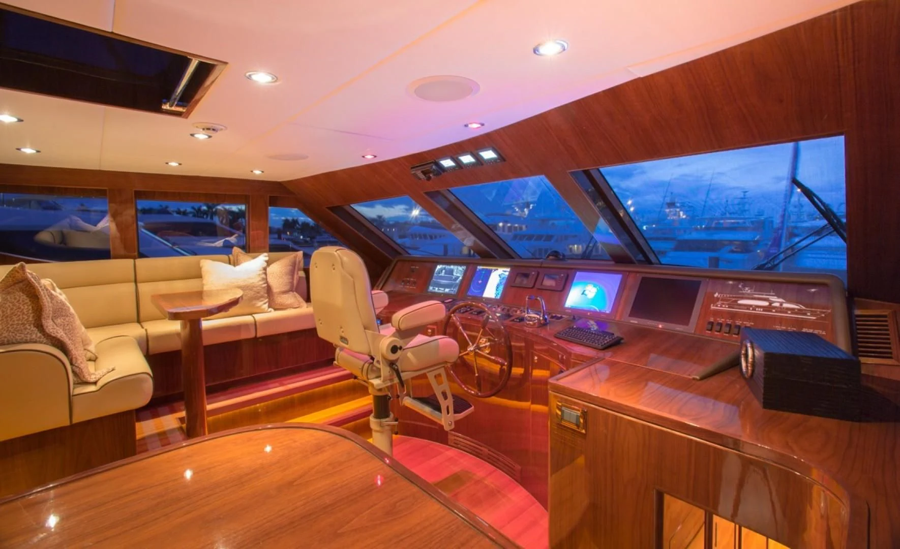 inside of a vehicle with a large screen and a table with chairs and a large window with a aboard EBITDA Yacht for Sale