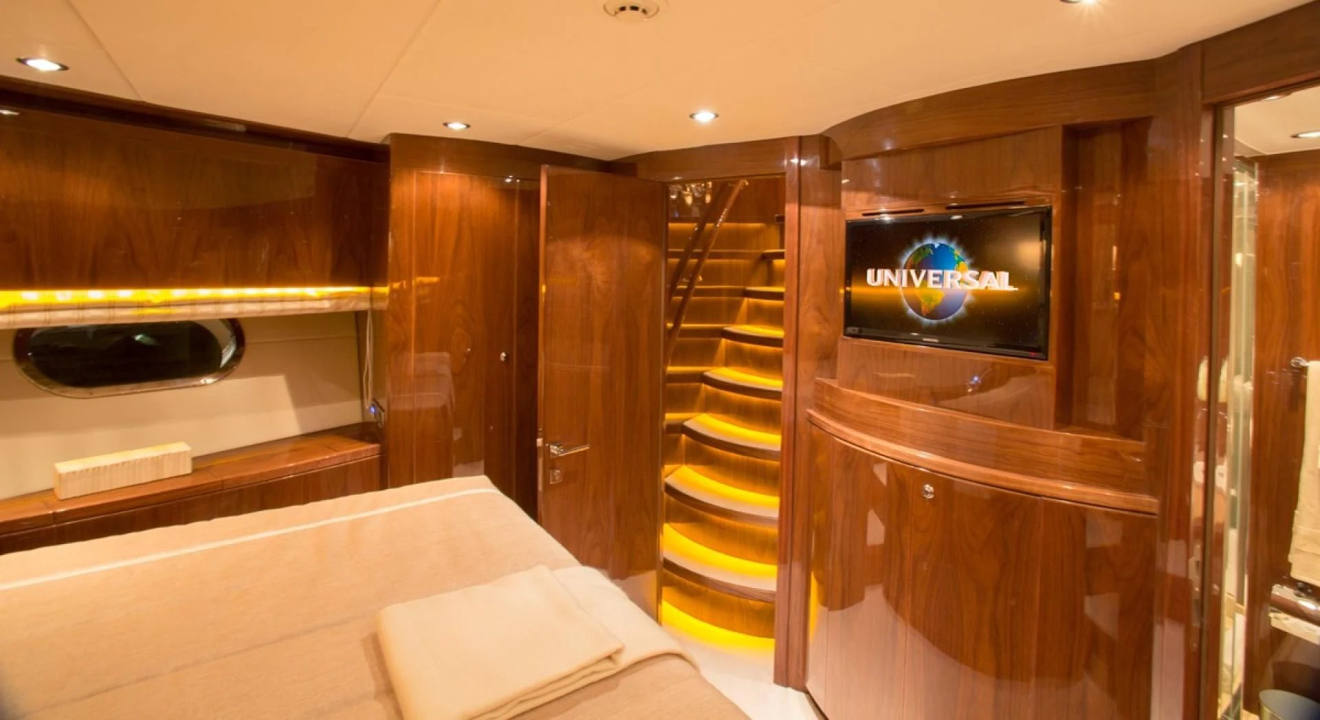 a room with a tv and a bed aboard EBITDA Yacht for Sale