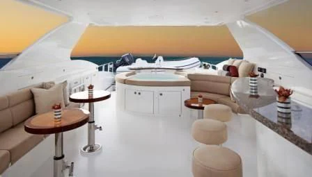 a room with a couch and a table aboard EBITDA Yacht for Sale
