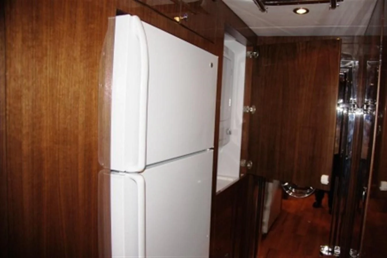 a kitchen with a refrigerator aboard EBITDA Yacht for Sale