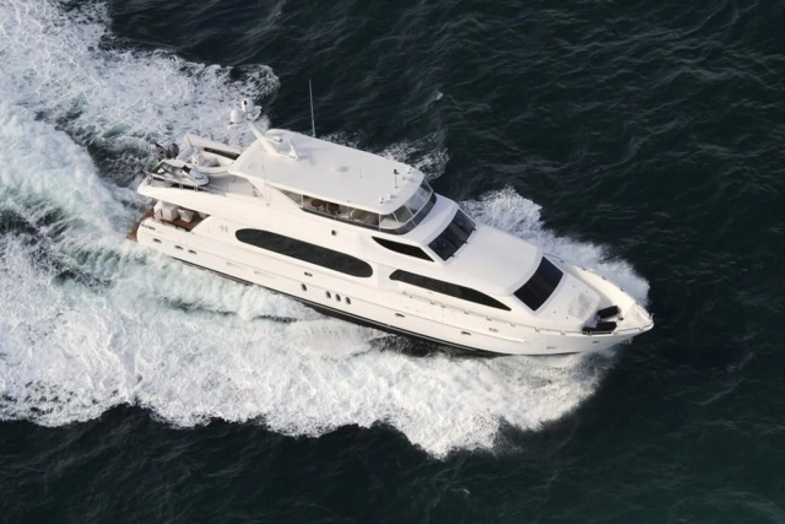 a white yacht in the water aboard EBITDA Yacht for Sale
