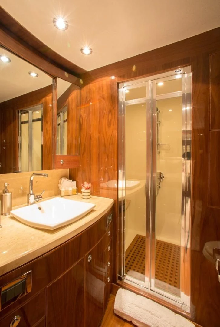 a bathroom with a shower and sink aboard EBITDA Yacht for Sale
