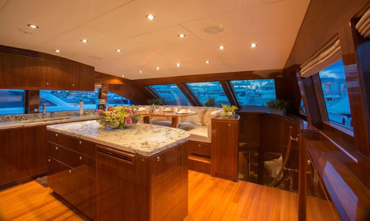 a room with a table and chairs aboard EBITDA Yacht for Sale